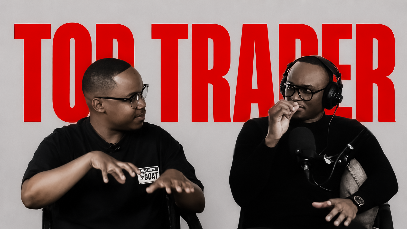Two Top Trader Network hosts in conversation on set, with large red TOP TRADER lettering behind them